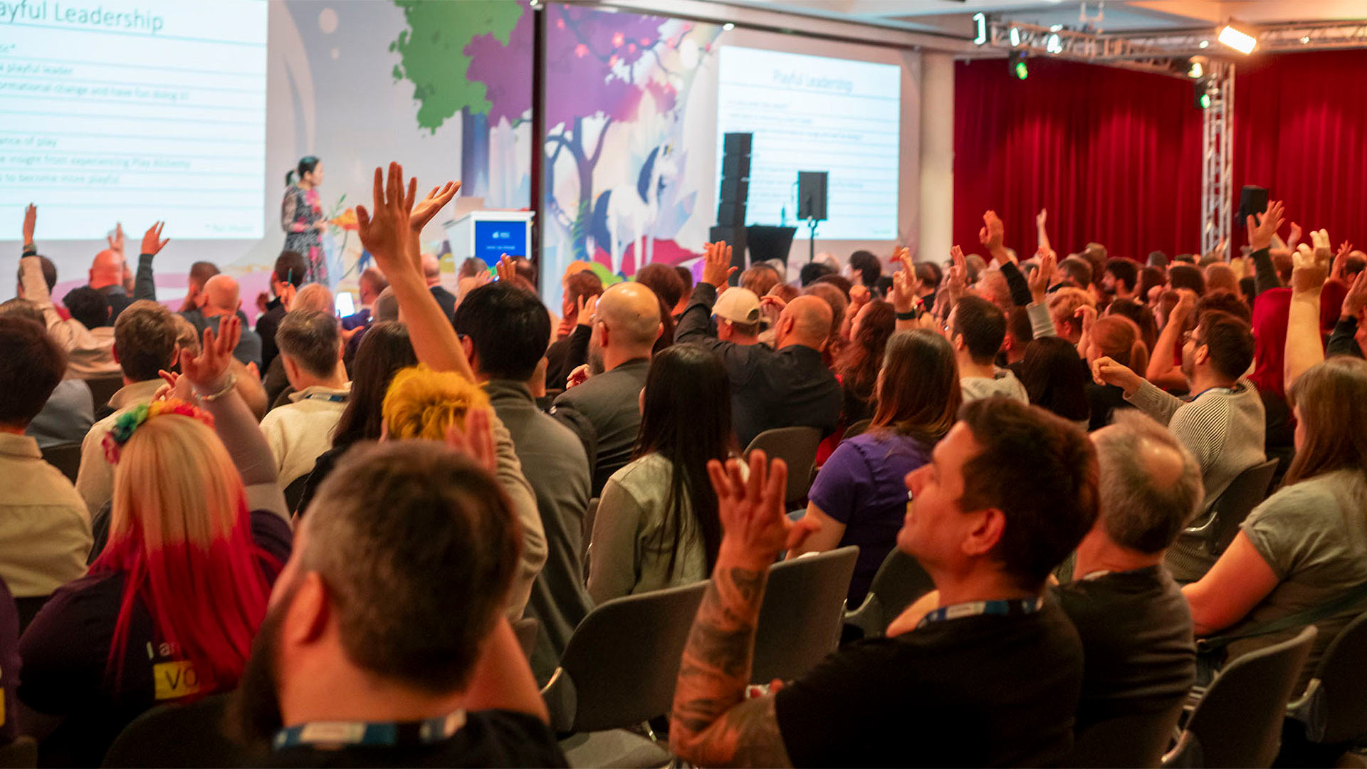 <p>AgileTD 2024 Keynote Audience, raising hands.</p>