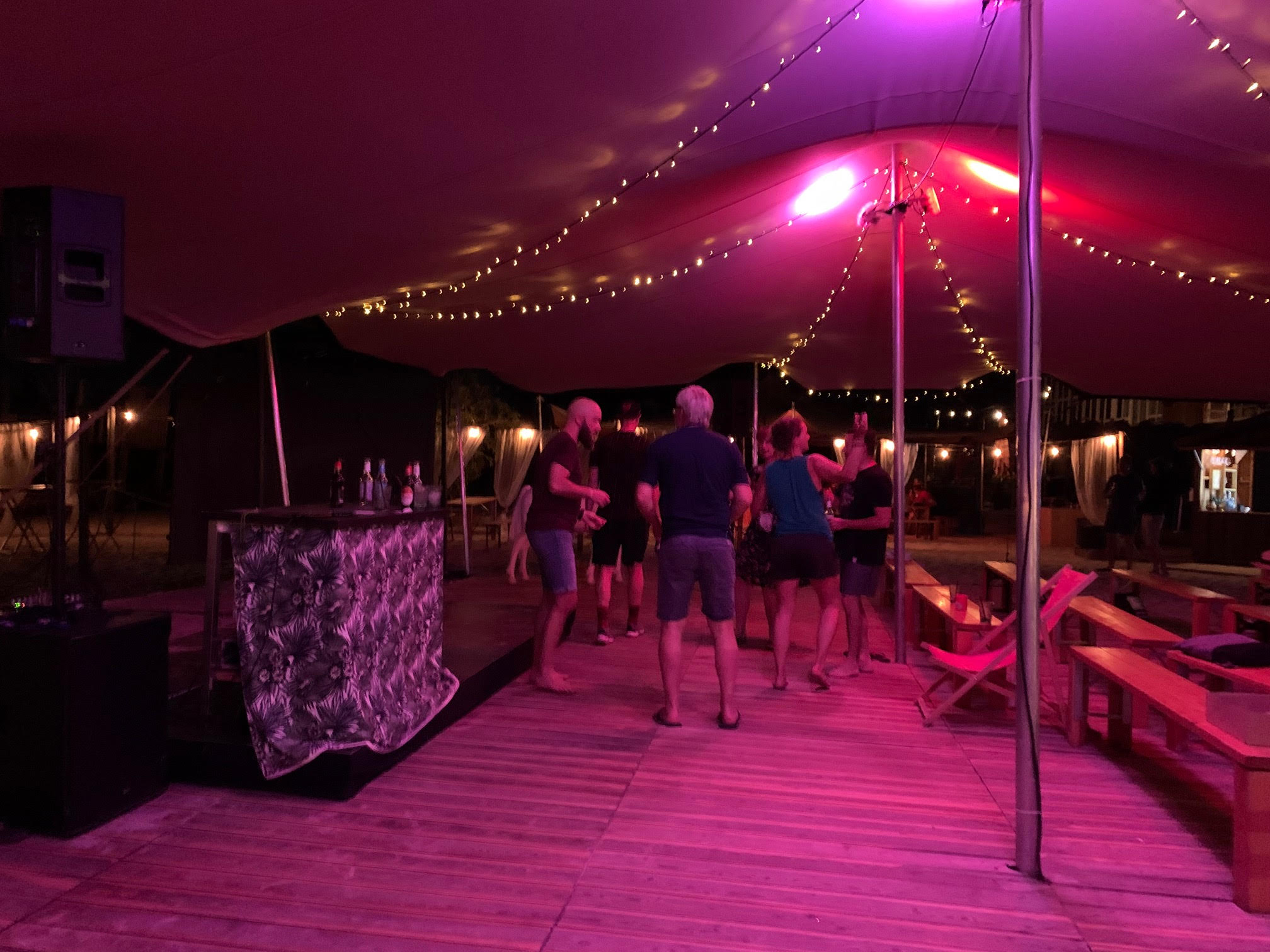 Night party at Open Air, people dancing under the open tent